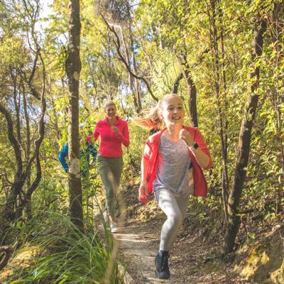 A family runs along the path of Fensham Reserve in Wairarapa.