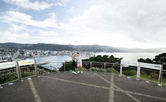 Two people take a selfie together at the Mount Victoria Lookout overlooking Wellington.