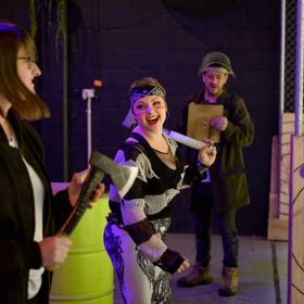 People throwing axes at Sweet Axe Throwing Co.