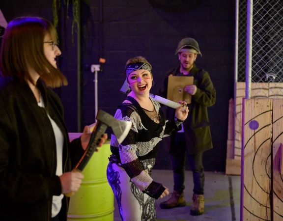 People throwing axes at Sweet Axe Throwing Co.