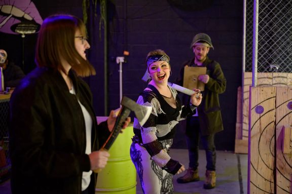 People throwing axes at Sweet Axe Throwing Co.