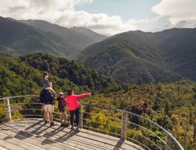 Two adults and two children are at the Rocky Lookout, on Mount Holdsworth in the Tararua Forest Park.