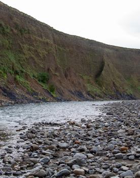 The screen location of Te Mārua  cliffs, where a river flows against vertical cliffs on the foothills of the Remutaka Range.