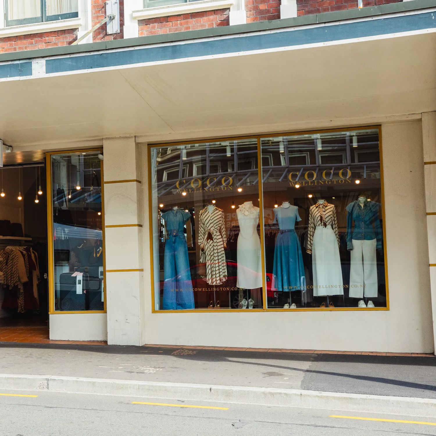 Exterior of Coco Wellington boutique fashion store, with clothing on mannequins in the window.