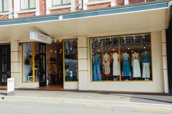 Exterior of Coco Wellington boutique fashion store, with clothing on mannequins in the window.