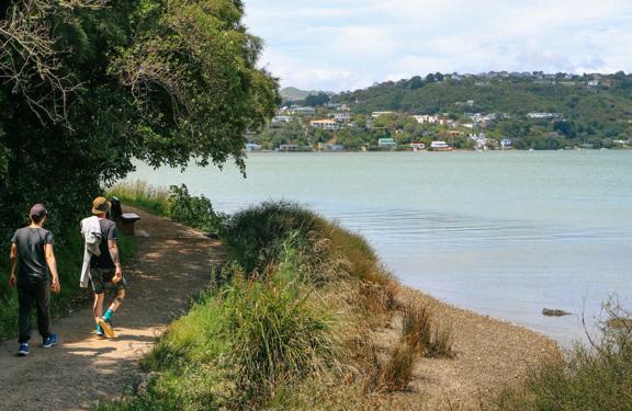 Two people walking on the Camborne Walkway trail.