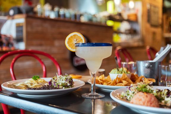 A frozen lime margarita and three Mexican dishes are on a table at Viva Mexico, a restaurant on Jackson Street in Petone, Lower Hutt, Wellington.