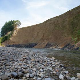 The screen location of Te Mārua  cliffs, where a river flows against vertical cliffs on the foothills of the Remutaka Range.