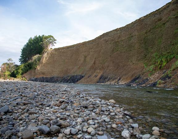 The screen location of Te Mārua  cliffs, where a river flows against vertical cliffs on the foothills of the Remutaka Range.