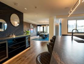 A room inside Wyndham Wellington with a alrge kitchen, dining room and views of the city.