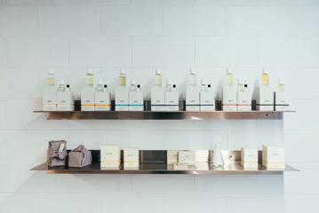 Shelf in the Abel Odor store displaying multiple perfumes and products.