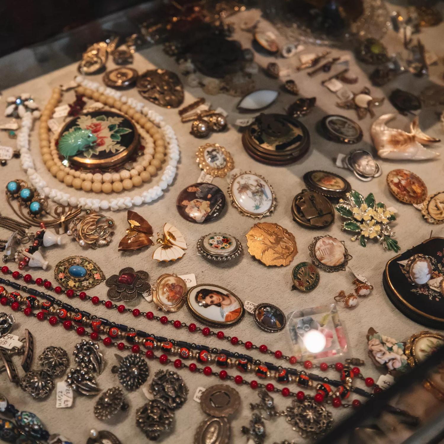 Antique earrings, necklaces and broaches, in a display case at Ziggurat, a secondhand store located in Wellington, New Zealand. 