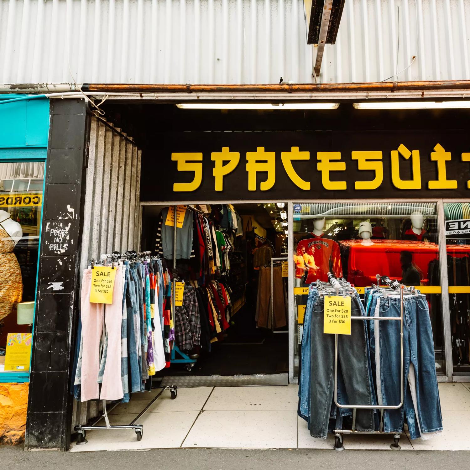 Three clothing racks outside the storefront of Spacesuit, a secondhand clothing store on Cuba Street in Wellington.