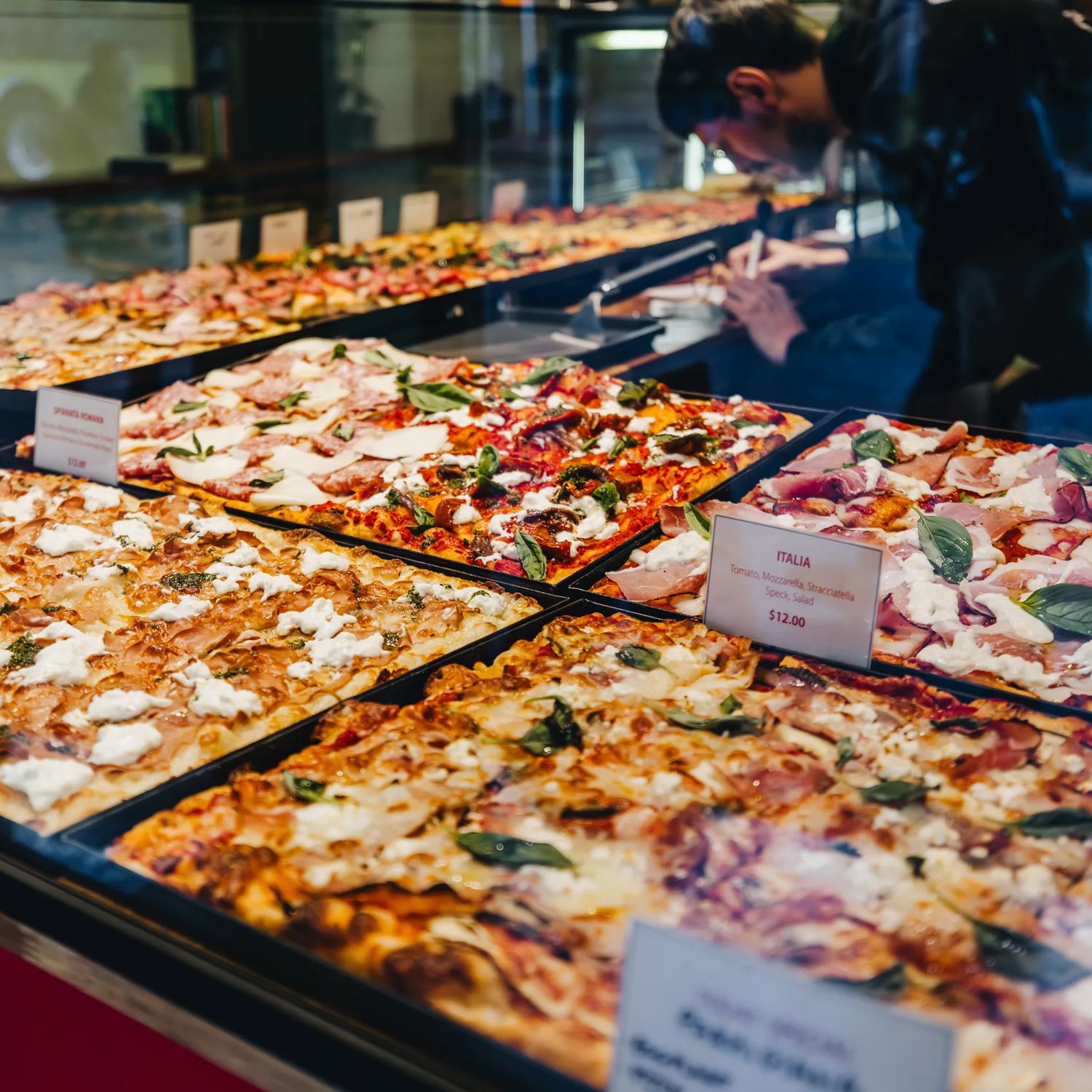 Pan pizzas on display at Spizzico, a Roman-style pizza restaurant in Wellington.