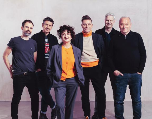 6 band members from Deacon Blue standing and smiling at the camera