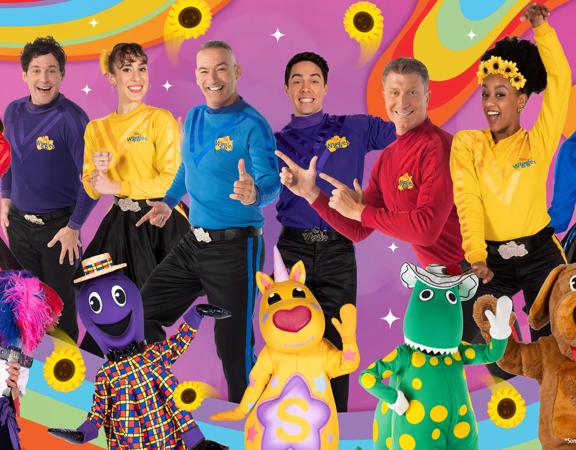 The Wiggles characters doing funky poses with a colourful background.