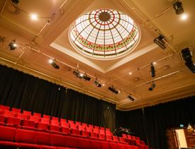 The gold and red interior of Bats Theatre.