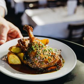 Duck confit with roasted potatoes at Le Bouillon Bel Air, a French restaurant in Wellington.