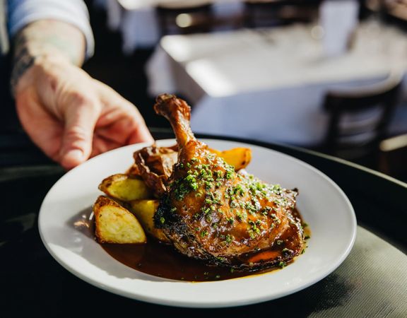 Duck confit with roasted potatoes at Le Bouillon Bel Air, a French restaurant in Wellington.