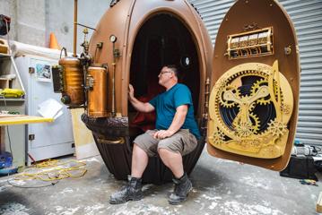 Matt Houghton of Human Dynamo sits and admires the submarine egg-shaped capsule he built for the film Avatar: The Way of the Water.