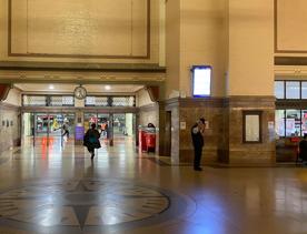 Interior of Wellington train station, an open space with a compass design on the floor.