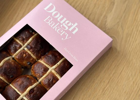A box of hot cross buns from Dough Bakery, a bakery in Te Aro, Wellington.