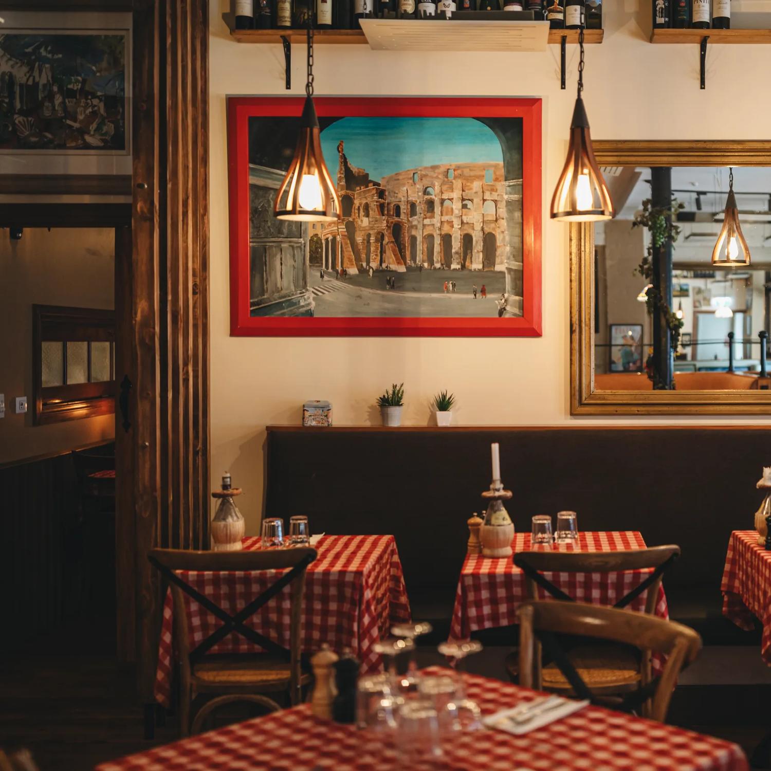 The interior of Nicolini’s, an Italian restaurant off of Courtenay Place in Wellington. The space has a warm atmosphere with wooden chairs, red and white checkered table clothes and rustic antique décor.