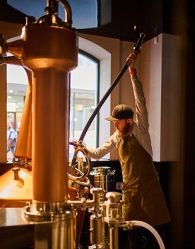 A worker at Woodward Street Distilling Company.