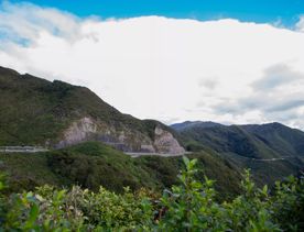 The screen location of Remutaka Summit, wit views of surrounding peaks, lush green bush and steep roads cut into the sides of the mountains.