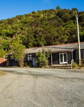 Camp Wainuiomata screen location. Has several buildings and is surrounded by forest and bush.