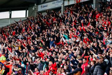 The crowd at a Wrexham AFC game celebrate.
