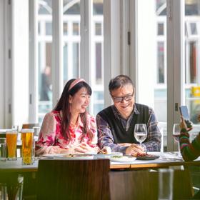 Two people enjoy food and drinks at Dockside Restaurant & Bar.