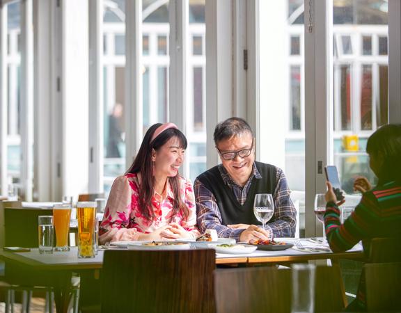 Two people enjoy food and drinks at Dockside Restaurant & Bar.