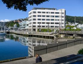 The Chaffers Dock apartment building sits on the edge of the marina. It's an art deco style building painted grey and white.