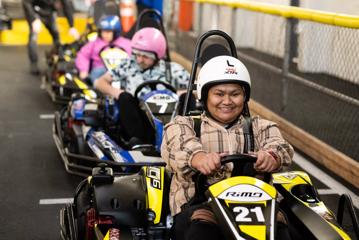 Person smiling whilst sitting on a go-kart at Daytona Adventure Park in Upper Hutt.