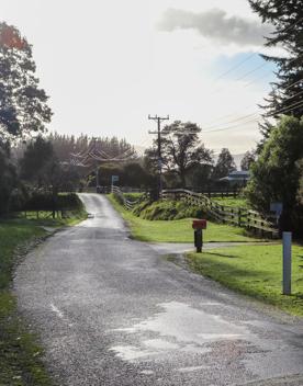 Mangaroa Valley Road screen location, a scenic rural setting with native forest, farmland, and a mountainous backdrop.