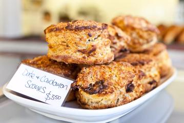 A plate of golden brown date and cardamom scones.