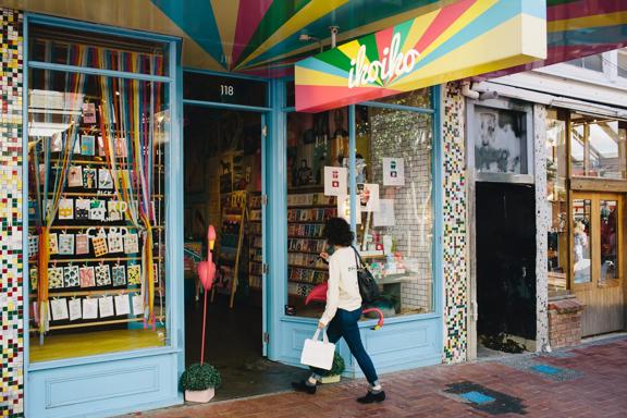 The vibrant exterior of Iko Iko with a person walking inside.