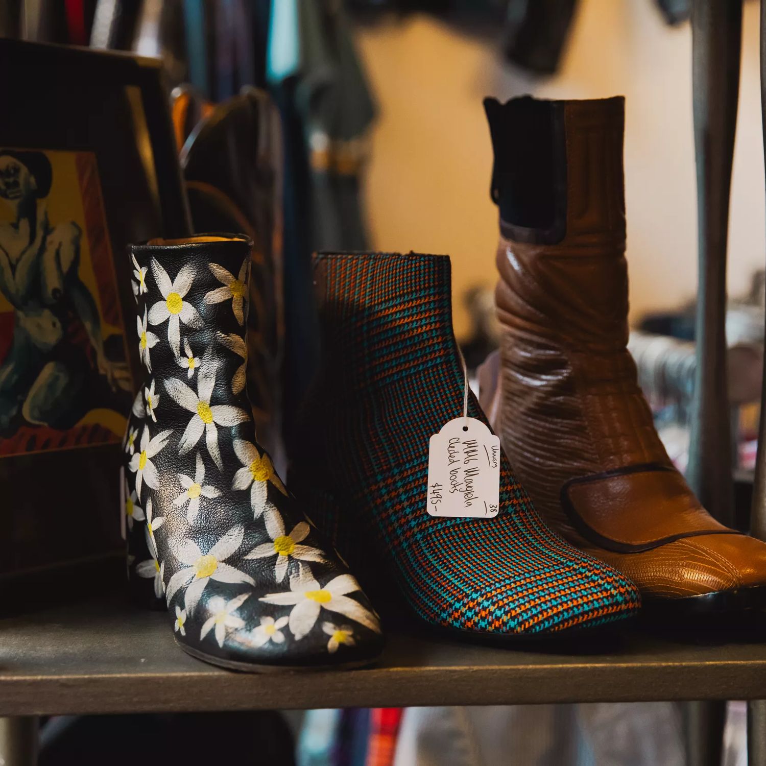 Patterned and leather boots displayed on a shelf at Hunters & Collectors in Wellington.