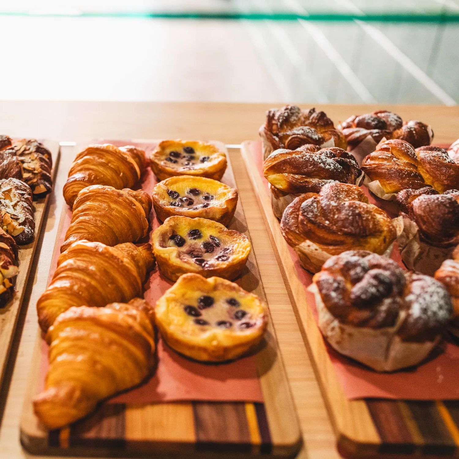 Croissants, pastries, and muffins inside a cabinet at Volco, Kelburn.