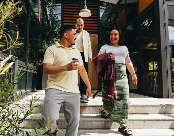 Three friends leaving Prefab cafe.