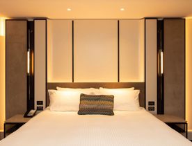 A classic room at the InterContinental has a bed with crisp white sheets.