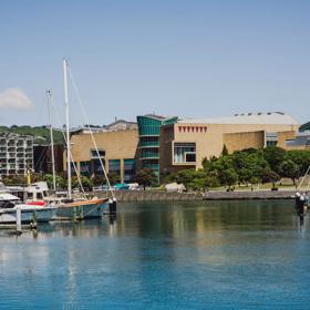 Boats are moored on the Wellington waterfront. Te Papa is in the background.
