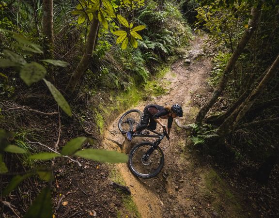 Mountain biker going around a sharp corner on the 491 track in Waiu Park