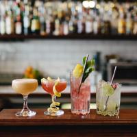 Four colourful cocktails lined up on the counter at Crumpet, a bar located on Manners Street in Te Aro, Wellington. 