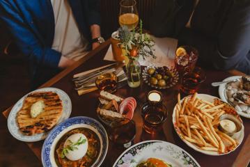 An assortment of dishes and drinks on a table at The Ram, a restaurant on Cuba Street in Te Aro, Wellington.