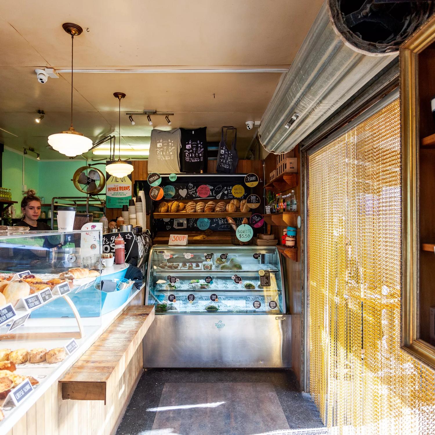 The interior of Olde Beach Bakery Waikanae. It's a small space with the counter along the left and back wall.