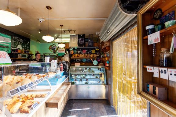 The interior of Olde Beach Bakery Waikanae. It's a small space with the counter along the left and back wall.