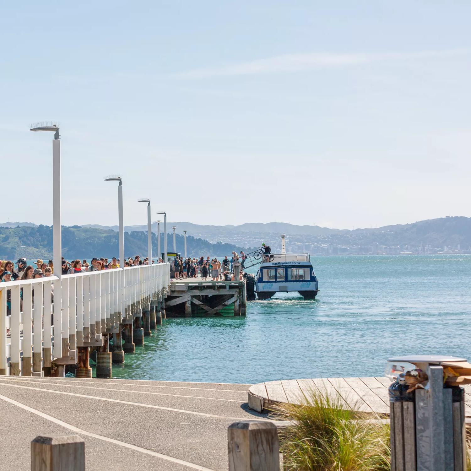 Passengers disembark the East By West Ferry on the Days Bay wharf.