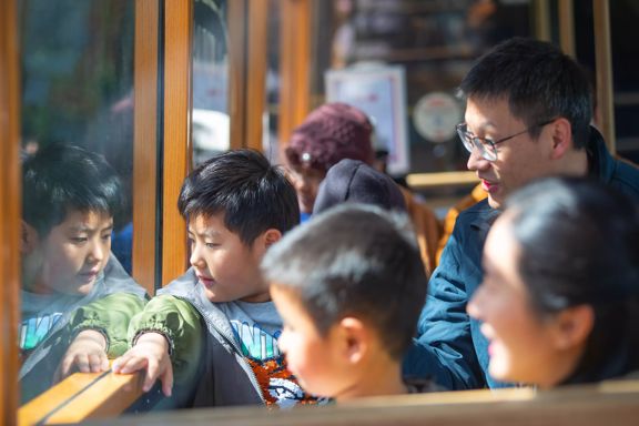 A family of four rides the Wellington Cable Car.
